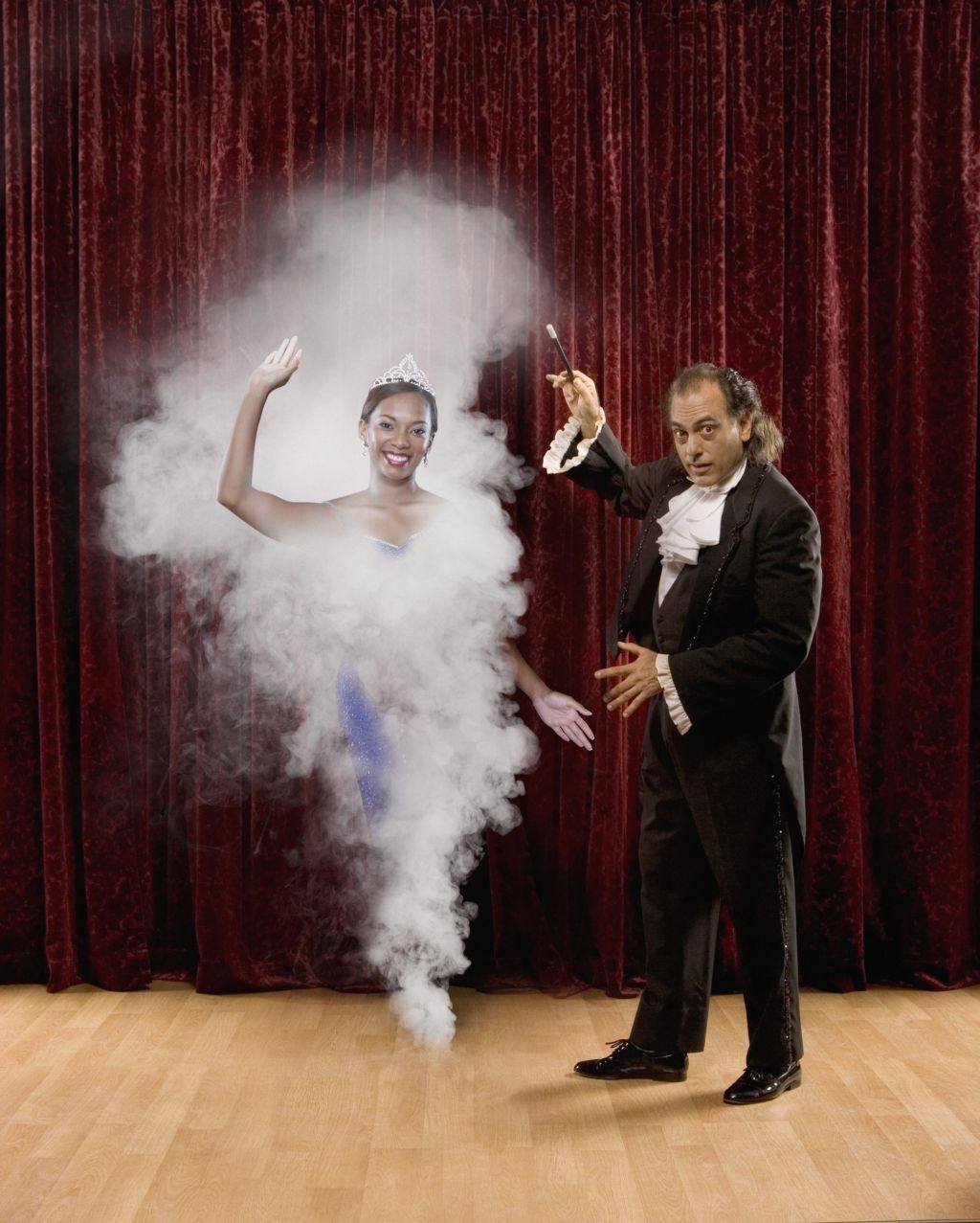 Magician making woman appear out of thin air