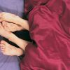 Couples Feet Together in Bed