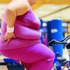 Mid Section View of a Fat Woman on an Exercise Bike