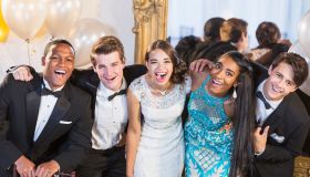 Teenagers and young adults in formalwear at party