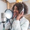 Woman singing at a recording studio