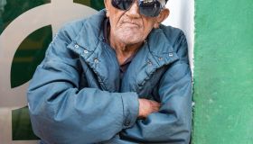 Cuban senior selling Trabajadores newspaper. Elders make...