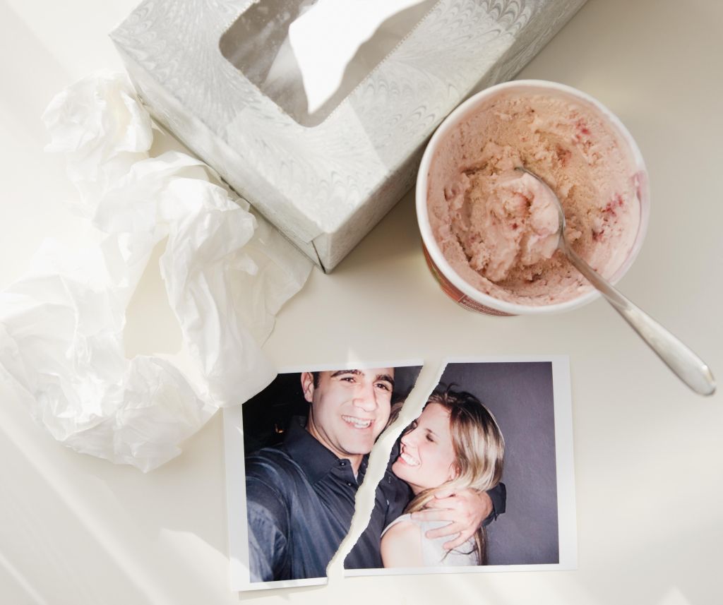 Ripped photograph next to ice cream and tissues