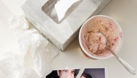 Ripped photograph next to ice cream and tissues