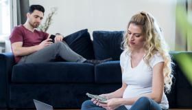 Pregnant woman is calculating family budget