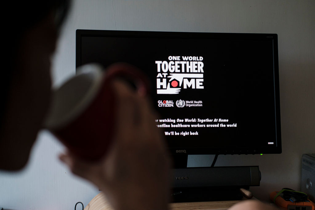 People Watch 'One World: Together At Home' In Hong Kong