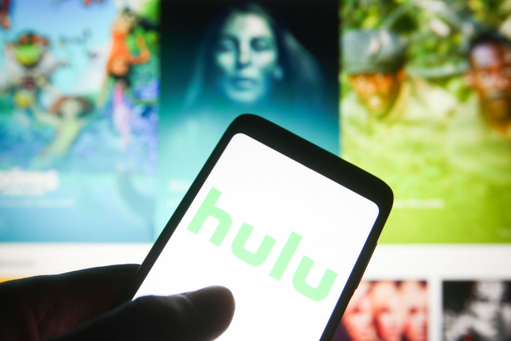 In this photo illustration a Hulu logo is seen on a...