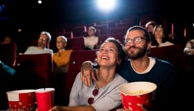 Young couple enjoying a fun movie at the cinema